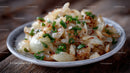 Cooked Onion Side Dish with Green Garnish on Rustic Plate