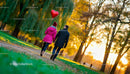 Couple enjoying autumn walk with heart-shaped balloon