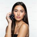 Elegant Woman Holding Fresh Black Grapes with Confident Smile