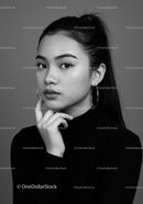 Elegant Black and White Portrait of a Young Woman with Confident Expression