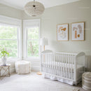 Bright and Cozy Nursery with White Crib and Abstract Art