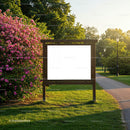 Empty wooden signboard in sunny park with blooming flowers
