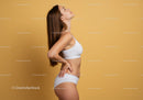 Elegant Female Fitness Model Posing in White Sportswear on Yellow Background