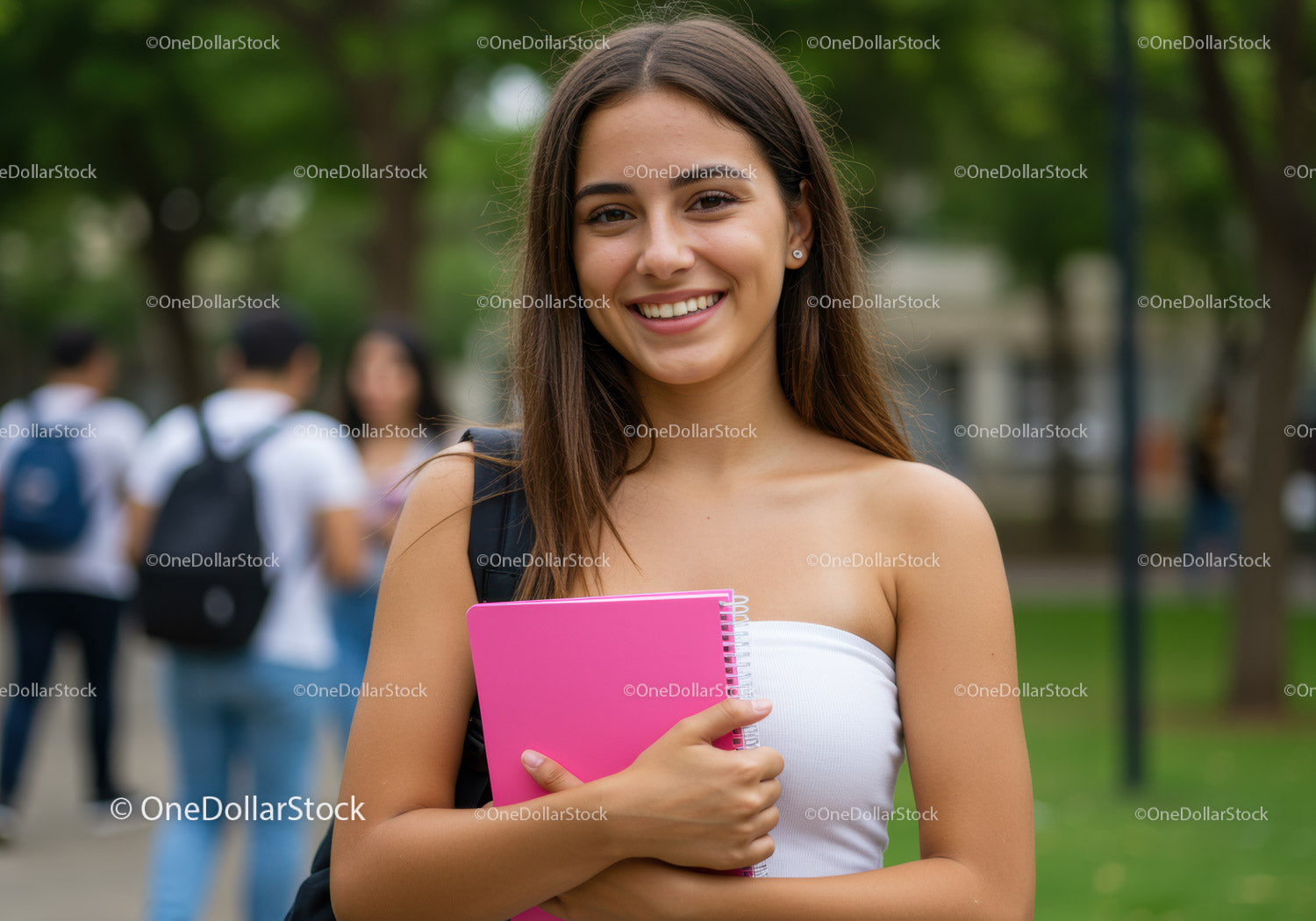Young Smiling Woman with Pink Notebook in College Campus
