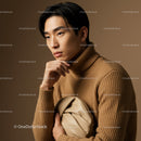 Elegant Young Man in Beige Turtleneck Holding Clutch Bag Studio Portrait
