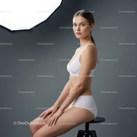 Elegant Female Portrait in Studio with Soft Lighting and Minimalist Background