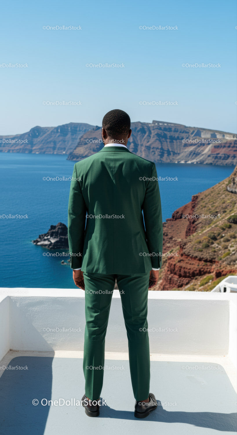 Man in Green Suit Admiring Mountain View by the Sea