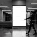 Blurred businessman walking in modern lobby with blank sign
