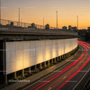 City Highway Overpass at Sunset with Light Trails and Skyline