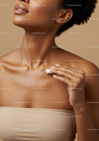 Beautiful Woman Applying Lotion to Shoulder for Glowing Skin
