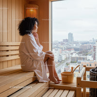 Serene Woman Sitting in Sauna with City View Behind