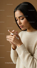 Young Woman Applying Lotion in Skincare Routine with Beige Sweater