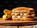 Banana and Peanut Butter Sandwich on Rustic Wooden Surface