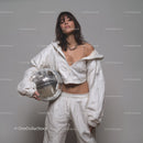 Stylish Woman in Metallic Outfit Holding Disco Ball for Modern Fashion