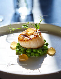 Seared Scallop on Fresh Green Peas with Herb Garnish