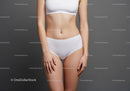 Elegant Female Model in White Underwear Against Minimalistic Gray Background