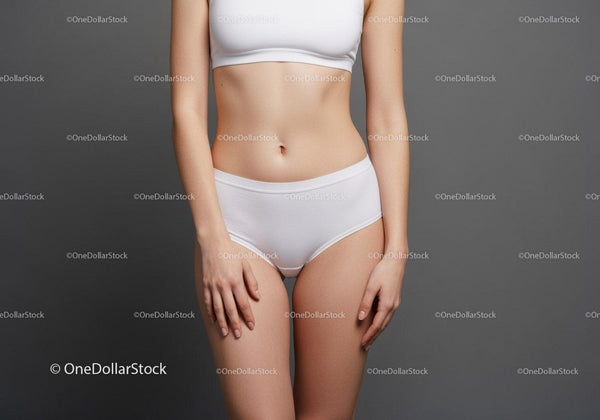 Elegant Female Model in White Underwear Against Minimalistic Gray Background