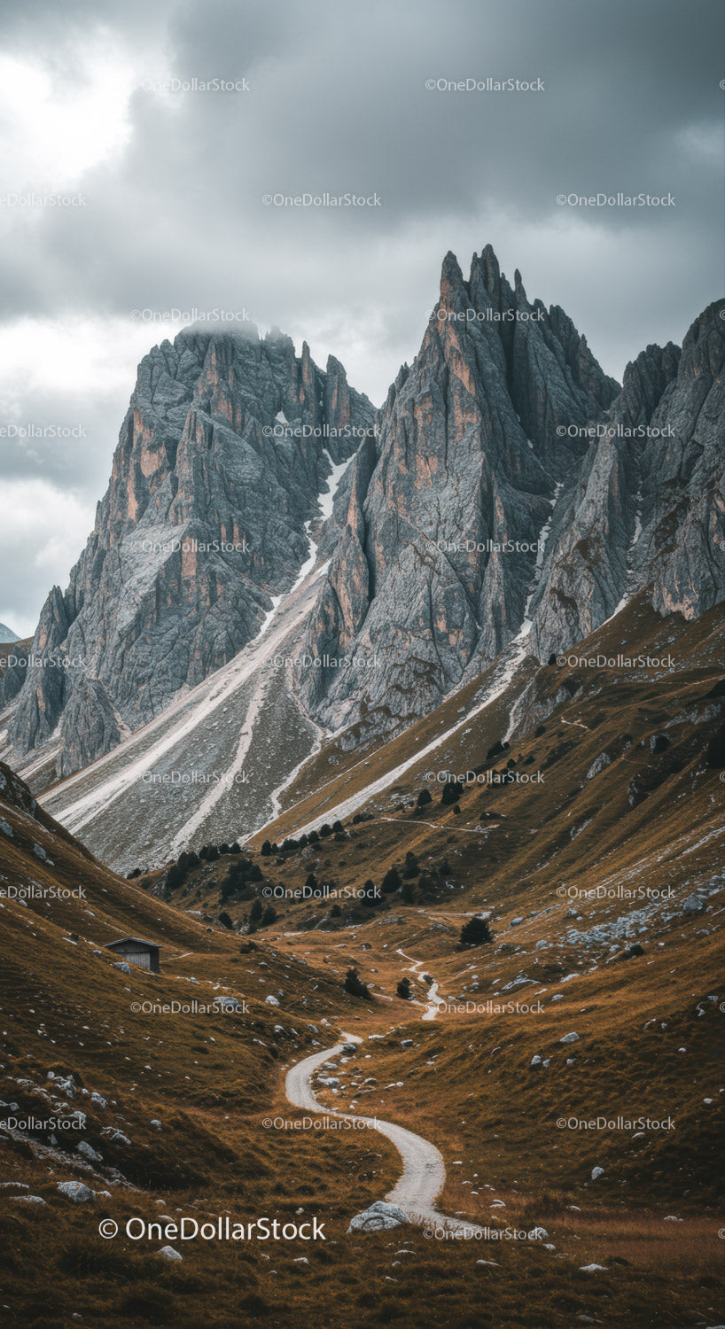 Majestic Rocky Mountain Peaks Under Stormy Sky with Scenic Trail