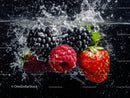 Strawberries, Blackberries and Raspberry Splashing into Water