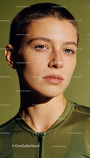 Close-up of athlete with short hair in green sportswear