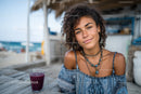 Young Woman Smiling at Beachside Cafe During Summer Vacation