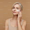 Elegant Woman Applying Skincare Cream for Youthful Skin
