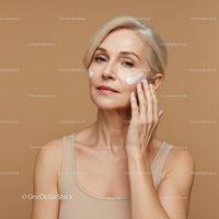 Elegant Woman Applying Skincare Cream for Youthful Skin