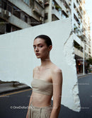 Contemporary woman posing against urban white wall