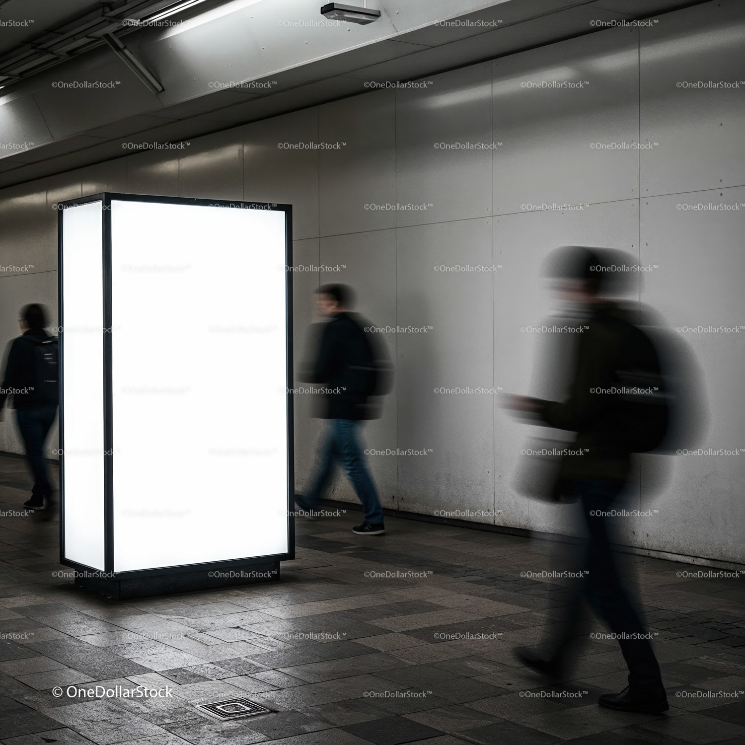 Blurred commuters walking past illuminated urban billboard