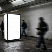 Blurred commuters walking past illuminated urban billboard