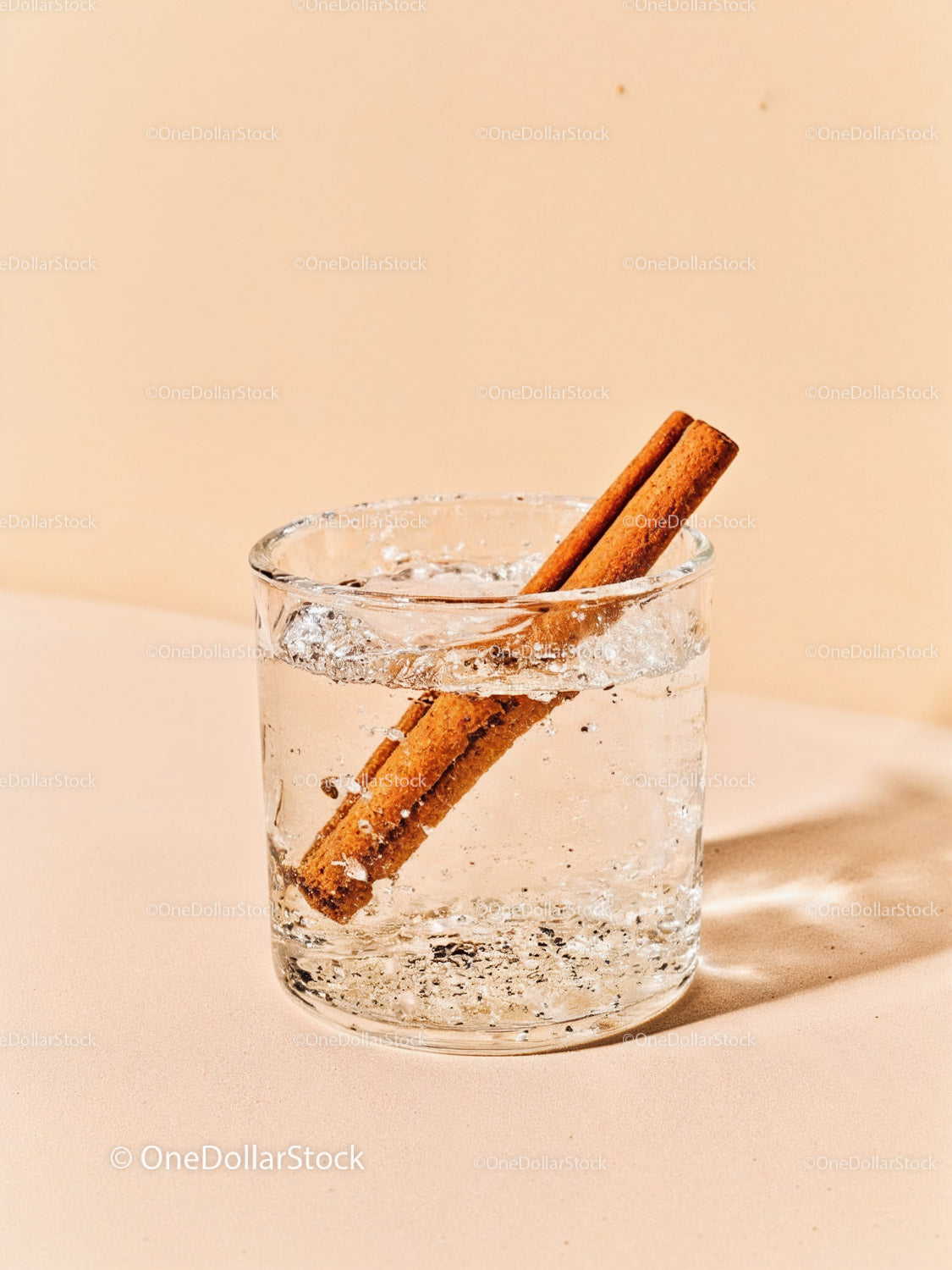Glass of Sparkling Water with Cinnamon Sticks
