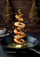Sliced apple with cinnamon and oats over sizzling butter