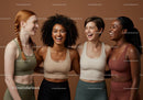 Happy diverse women laughing together in activewear