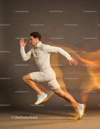 Athletic young man sprinting with motion blur effect