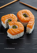 Fresh Salmon Avocado Sushi Rolls on Black Slate Plate