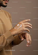 Close-up of a Man Applying Lotion on Hands for Skincare Routine