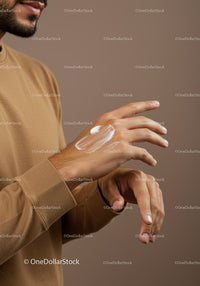 Close-up of a Man Applying Lotion on Hands for Skincare Routine
