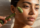 Young Woman Using Jade Roller for Skin Care and Facial Rejuvenation