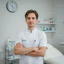 Professional Male Doctor in White Coat Standing in Medical Clinic