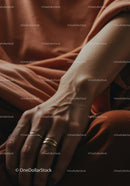 Close Up of Human Hand with Gold Rings and Skin Texture in Warm Tones