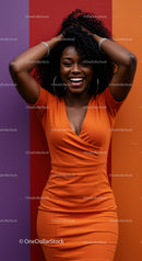 Vibrant Woman in Orange Dress Laughing Against Colorful Wall