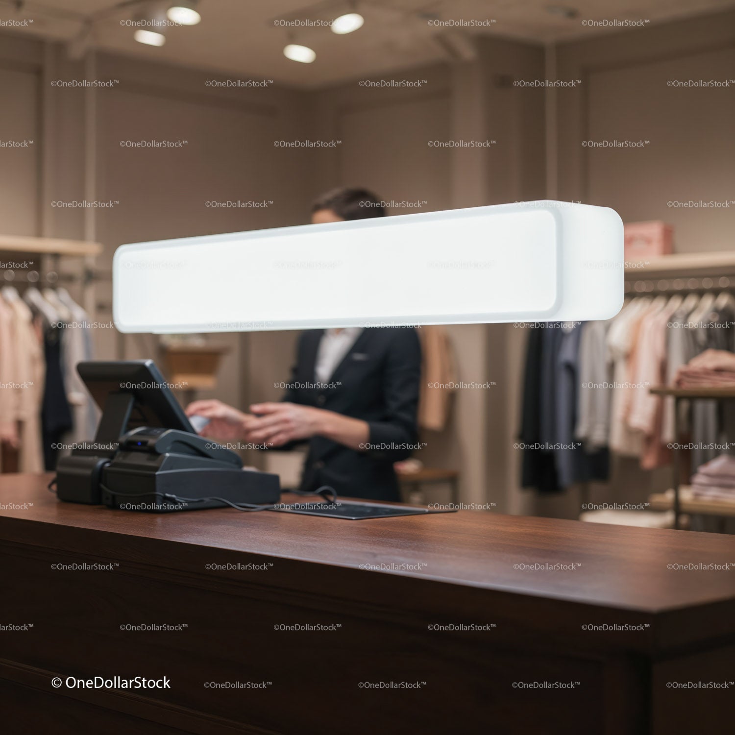 Retail counter with cashier and clothing racks background