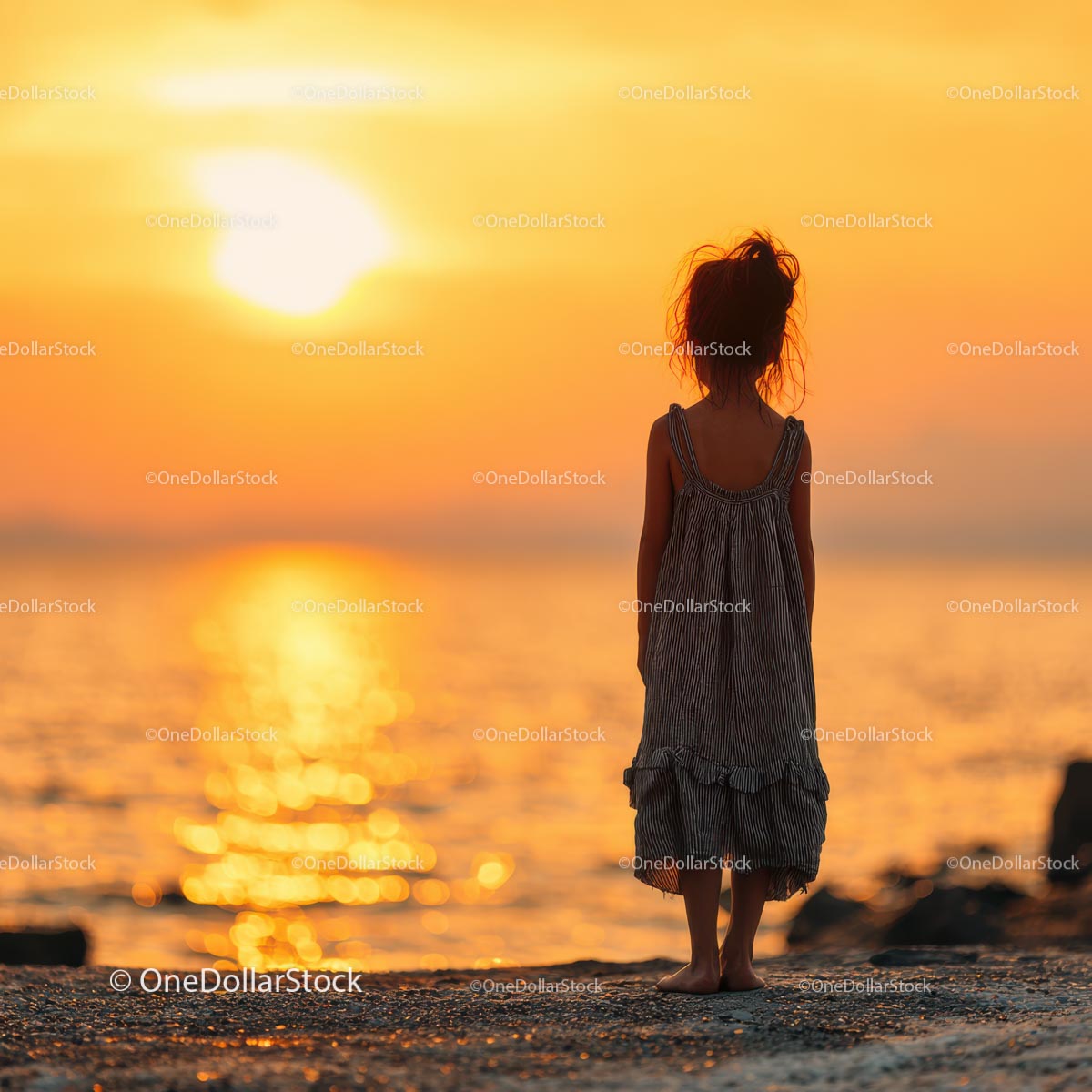Silhouette of a Child at Sunset by the Ocean Shore