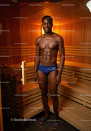 Healthy Male Model Relaxing in Sauna with Wooden Interior