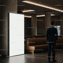 Business professional standing near blank illuminated signboard