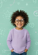 Smiling child with curly hair in purple sweater