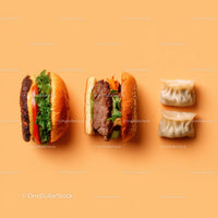 Gourmet Burger with Lettuce and Tomato Next to Grilled Steak and Dumpling