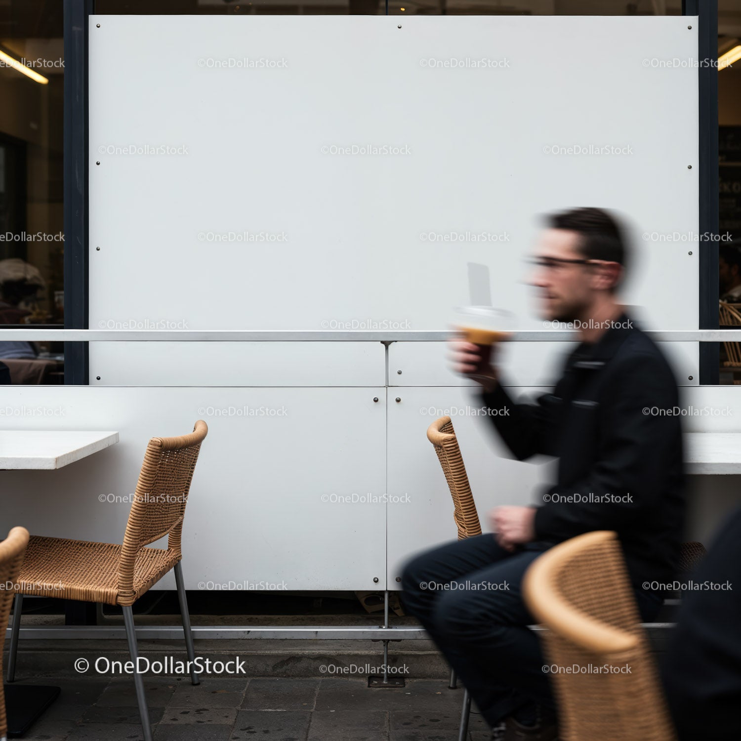 Blurred man drinking coffee at outdoor cafe seating