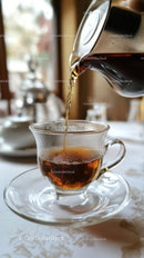 Hot Tea Being Pouring Into Glass Cup in Cozy Cafe Setting