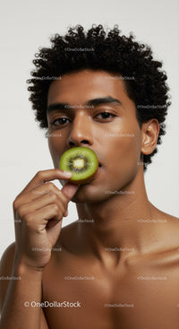 Young Man Holding Fresh Kiwi Fruit Close-Up Portrait